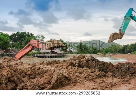 SATTAHIP CHONBURI - July,23 : Backhoe on the construction at digging the pit. Preparatory work for the construction of grain silos. The work of construction machinery in a quarry.THAILAND JULY,23 2015