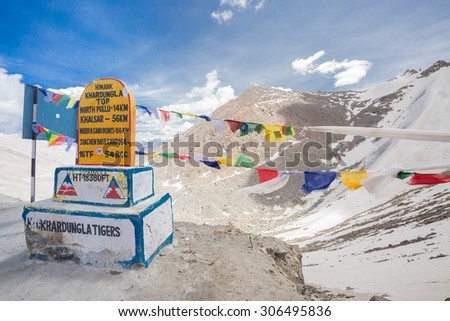 LEH LADAKH , INDIA - AUGUST 11 : A Siachen Brigade road sign and prayer flags at Khardung La pass in Leh Ladakh,India on August 11, 2015. The Worlds Highest Motorable Road at altitude 5602 m.