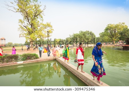 NEW DELHI, INDIA - AUGUST 4: The tourists are around the Indian gate in summer in New Delhi,India on August 4, 2015. The Indian gate is the national monument of India.