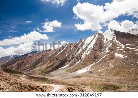 Altitude road and snowy rock mountain rage in summer