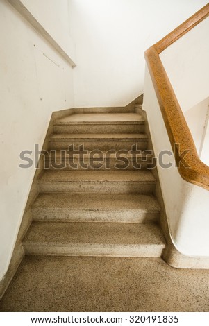 The empty stairwell with a wooden hand rail toned with a retro vintage