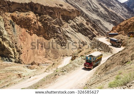 LEH LADAKH , INDIA - AUGUST 11 : The big colorful trucks on Indian Himalayas high altitude road in Leh Ladakh,India on August 11, 2015.