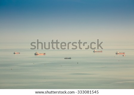 CHONBURI,THAILAND - OCTOBER 29 : The oil vessel is anchored  in sea shore in twilight time on October 29, 2015 in Chonburi, Thailand