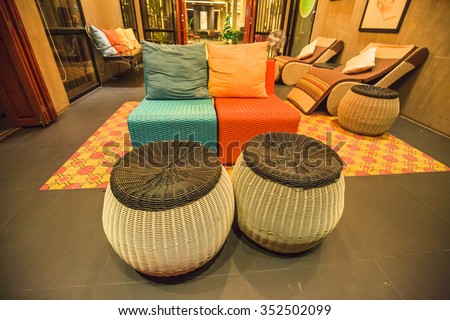 AMPAWA, THAILAND - DECEMBER 15: The living room interior design with sofa, armchair and colorful pillows in famous vintage hotel at ancient Ampawa, Thailand on December 15, 2015.