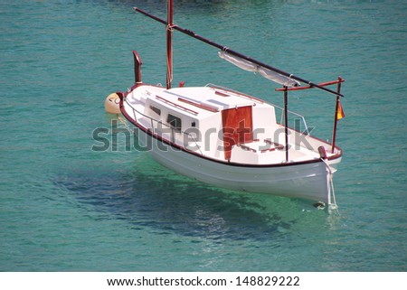 A typical mediterranean recreational / fishing boat in crystal clear turquoise water