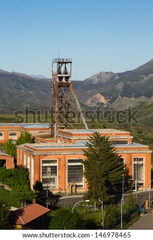Ancient facilities of mine today closed in mountainous scenery. Central headframe castillete of the well of mine. Sotillos. Leon. Spain