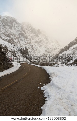 Mountain road in winter with approaching car Spain
