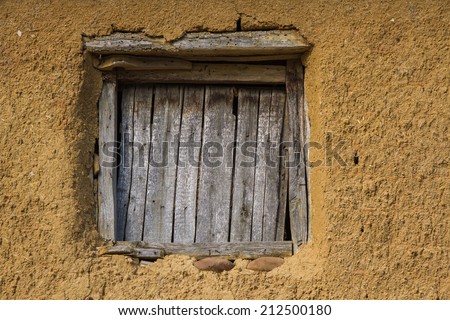 Mouth or window old wooden tables. House block or adobe or mud