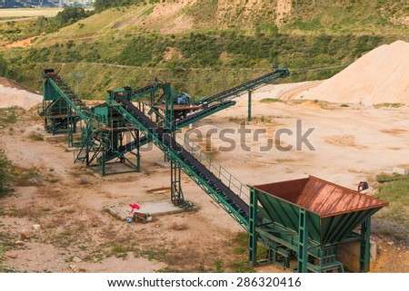 Recycling plant material gravel pit with ribbons distribution and gravel piles of gravel or sand for the construction industry