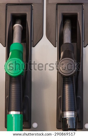 Two jet nozzles or hoses with tap for dispensing fuel at a gas station