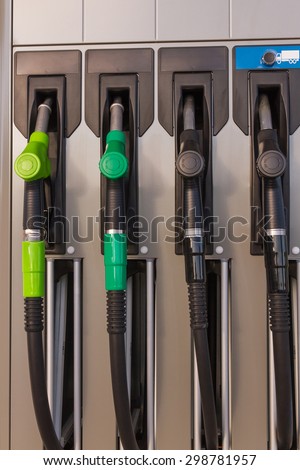 Fuel pumps or dispensers in Gas - Four jet nozzles or hoses with tap for dispensing fuel at a gas station