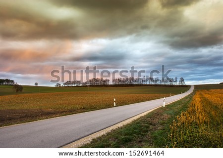 a country road during sunset after a thunderstorm