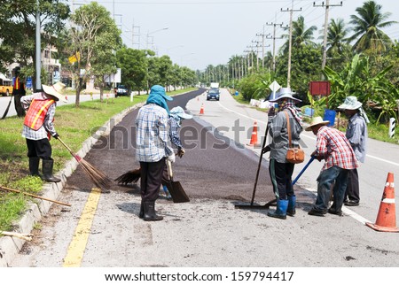 Group of workers working on Asphalt paving  on road renovation