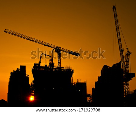 construction site - silhouette engineering building sunset project tower crane working