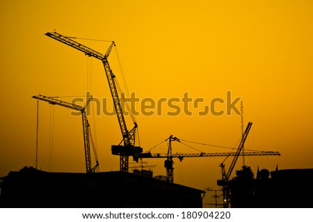 construction site - cranes tower sunset steel engineering industrial silhouette