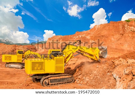 excavator digging lignite in open pit mine
