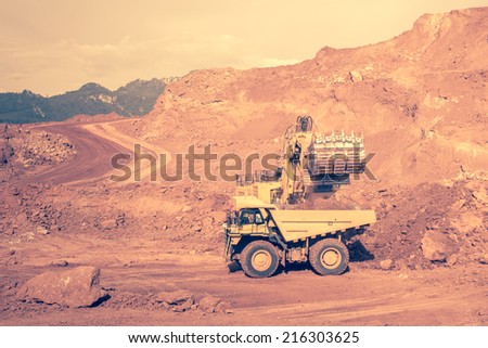 excavator at work in the open-pit mine - industrial machinery digger coal lignite