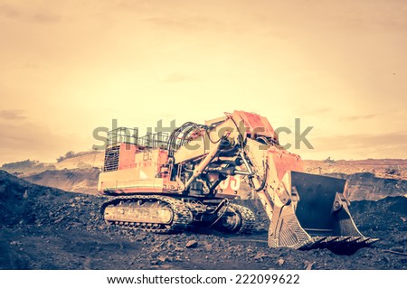 excavator at work in the open-pit mine - industrial machinery digger coal lignite