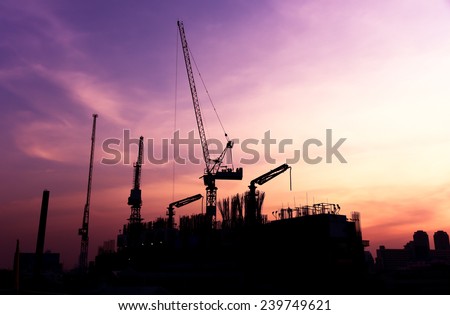 construction site - silhouette cranes building condominium