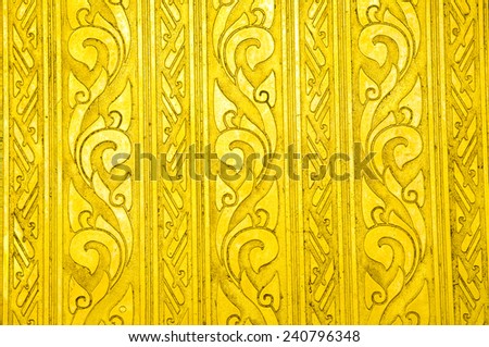 traditional Thai style art gold painting pattern on wall in temple