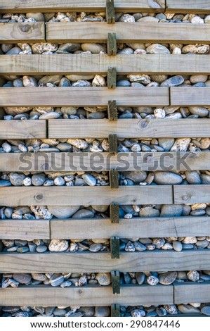 rock stone texture with wooden plank to keep together from falling off