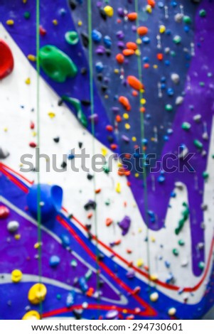 blurred image of indoor rock wall climbing