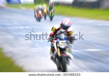 motorcycle racing -  winning leadership competing effort - blurred background motion blur