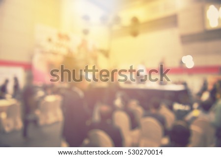 blur event seminar with activity on stage - blurred background -  bokeh light vintage tone. business concept.