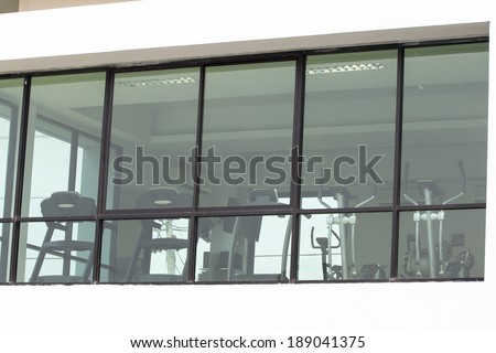 with high ceiling in front of a big glass window
