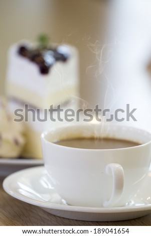 Coffee and bread on wooden table