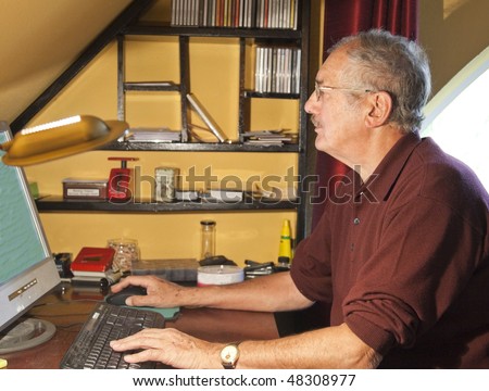 The senior computer user in his study.