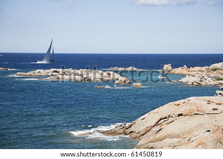 The sailboat sailing along the coast of Sardinia.