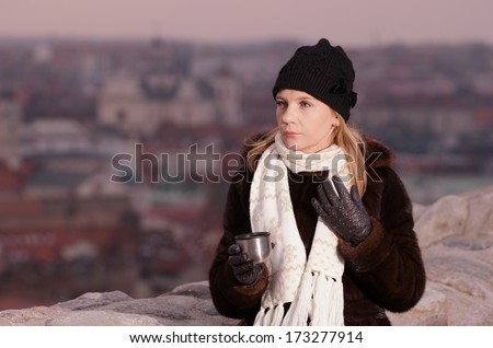 Young woman drinking coffee in Vilnius, Lithuania