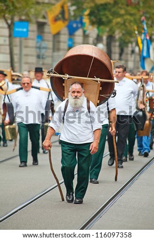 ZURICH - AUGUST 1: Swiss National Day parade on August 1, 2011 in Zurich, Switzerland. Representative of canton Appenzeller in a historical costume with cheese pan
