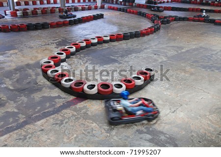 Race between safety barriers in indoor carting hall