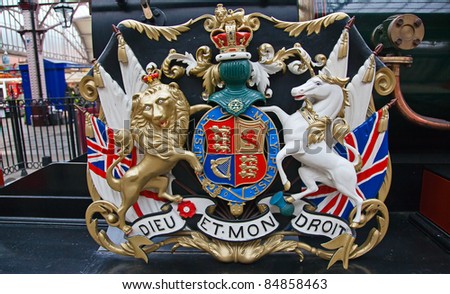 Lion and unicorn on English heraldic coat of arms on an ancient steam train in Windsor
