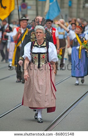 ZURICH - AUGUST 1: Woman in national costume taking part in Swiss National Day parade on August 1, 2011 in Zurich, Switzerland.