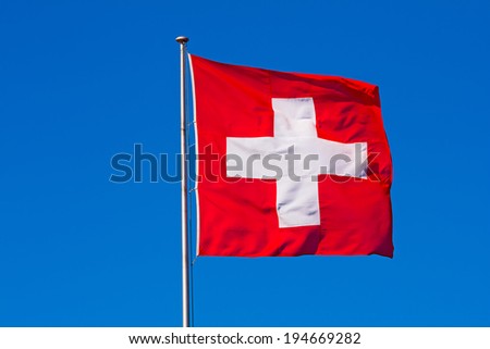 Swiss flag against blue sky