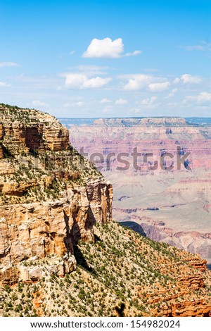 The grand canyon under the blue sky with some clouds