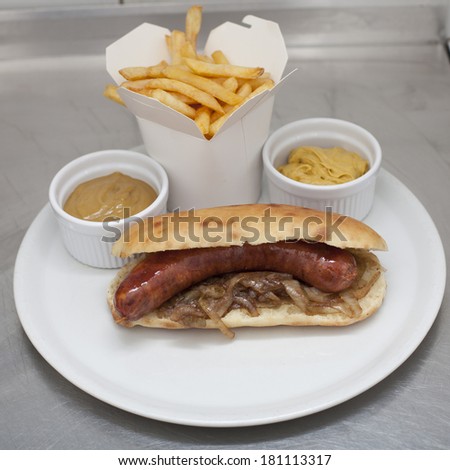 hot dog with french fries and mustard sauce served on plate, fast food menu