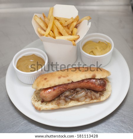 Grilled sausages with french fries and mustard sauce served on plate, hot dog, fast food menu