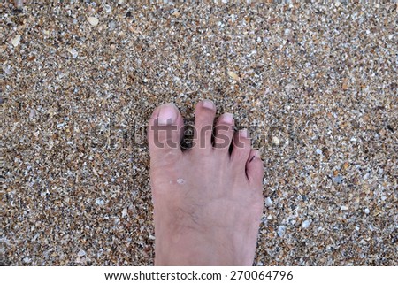 One Feet Standing In Sand