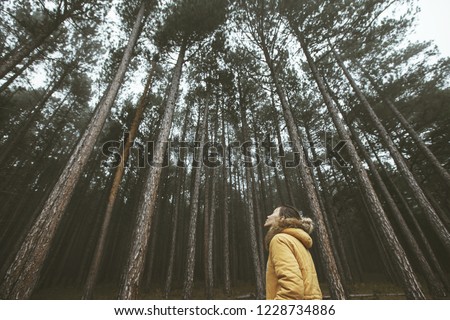 Woman hiker standing and deep breathing in forest in national park