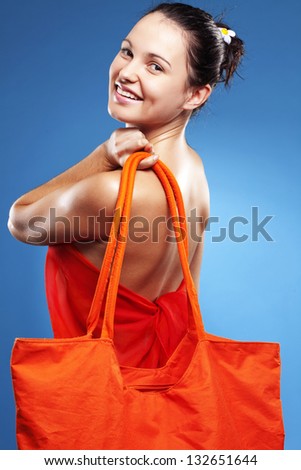 Beautiful young woman wearing big summer bag studio series