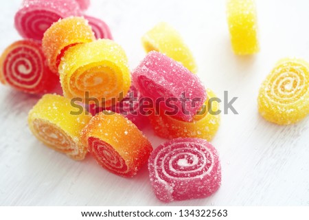 Sweet sugar candies on white wooden background