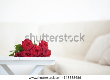 Bouquet of red roses in a room selective focus