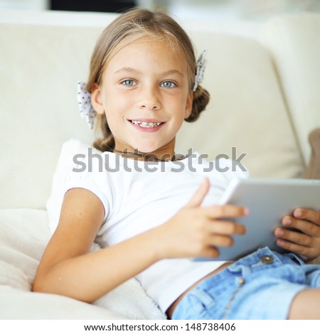 Child playing on ipad tablet pc at home
