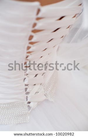 Detail of a woman 39s wedding dress gown showing curve of back with corset