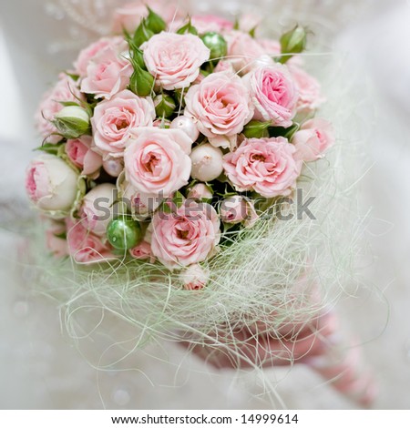 stock photo Wedding bouquet with pink roses in bride hand