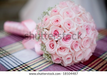 stock photo Wedding bouquet with pink roses on checkered backdrop